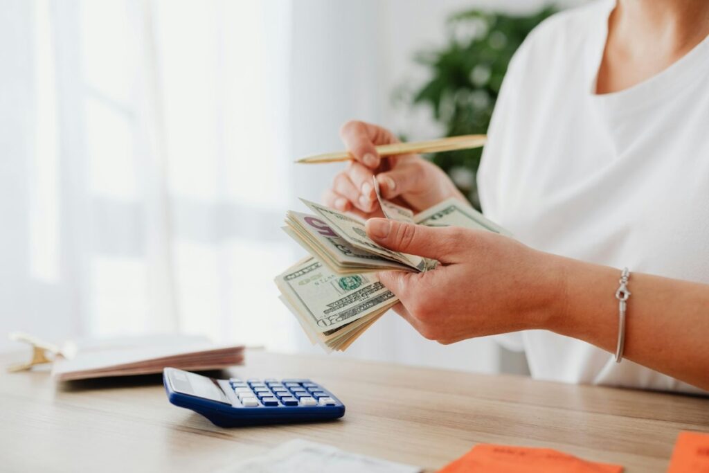 calculator pencil and women counting dollars