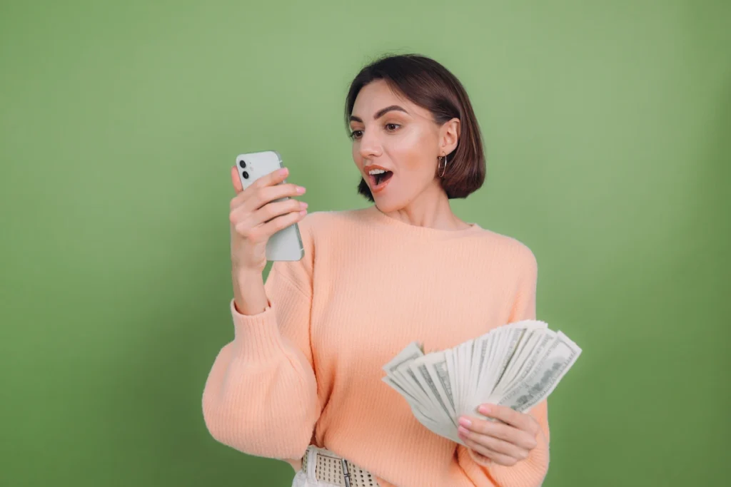 women suprisingly seeing her phone becaue of the hidden markup of digital money transfer 